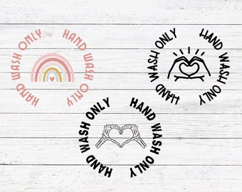 May include: Three circular designs with the text "Hand Wash Only" in black text around the outside of the circle. The first design features a rainbow with a heart in the centre. The second design features two hands making a heart shape. The third design features two skeleton hands making a heart shape.