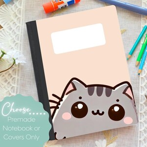 May include: A notebook with a light pink cover featuring a cartoon cat illustration. The notebook has a black spine and a white rectangular label. The text "Choose... Premade Notebook or Covers Only" is also visible.