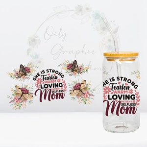 May include: A clear glass jar with a bamboo lid and a straw. The jar has a floral design with butterflies and the text "She is strong, fearless, warm, loving, patient, selfless, Mom".