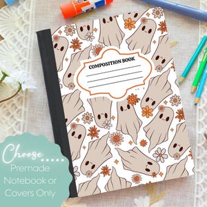 May include: Composition book with a white background and a pattern of tan ghosts and orange flowers. The cover has a label that reads "COMPOSITION BOOK". The notebook is a premade notebook or cover only.