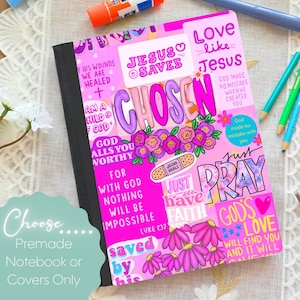 May include: A notebook with a vibrant pink cover featuring various religious phrases and illustrations. Text includes "Jesus Saves," "Chosen," "Love like Jesus," "God calls you worthy," "Just pray," and "God's love will find you."