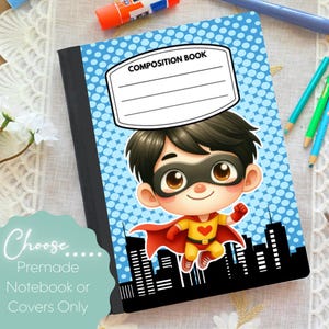 May include: A composition notebook with a blue dotted background and a cartoon superhero illustration. The cover features the text "COMPOSITION BOOK" and a cityscape silhouette.