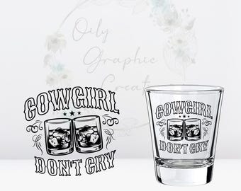 May include: A clear glass shot glass with a black and white design that says "Cowgirl Don't Cry" with two glasses of whiskey inside a stylized banner.