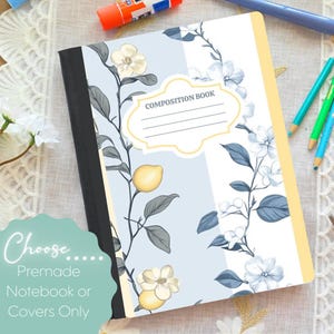May include: A composition book with a black spine and a light blue and white cover featuring a botanical pattern of yellow lemons and white flowers. A central white label with a yellow border contains the text COMPOSITION BOOK with four lines.