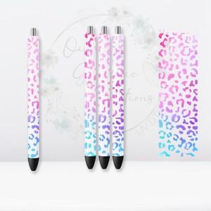 May include: Four white pens with a pink, purple, and blue ombre leopard print design.