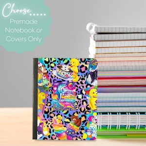 Op de afbeelding: Een notitieboek met een kleurrijke omslag met een collage van cartoonafbeeldingen, waaronder dolfijnen, puppy's en desserts, tegen een luipaardprint achtergrond. De tekst "Choose... Premade Notebook or Covers Only" is zichtbaar. Een stapel notitieboeken staat op de achtergrond.