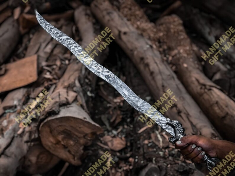 May include: A silver sword with a dragon head handle. The sword has a wavy pattern on the blade. The sword is held by a hand against a background of brown wood.