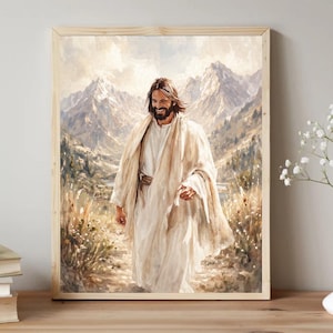May include: A framed wall art print depicting a bearded figure with long brown hair wearing a white robe and a beige shawl, walking along a dirt path through a grassy field with tall mountains and a cloudy sky in the background.