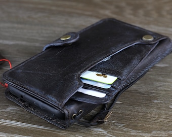 May include: A dark brown leather wallet with a flap closure and multiple card slots. The wallet is open and shows several cards inside.