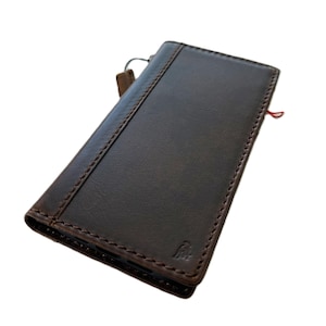 May include: A brown leather phone case with a zipper closure and a red string bookmark.