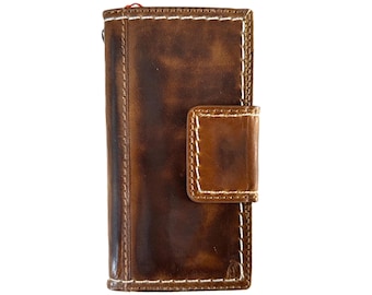 May include: A brown leather wallet with white stitching and a flap closure. The wallet has a distressed look and is made of high-quality leather.