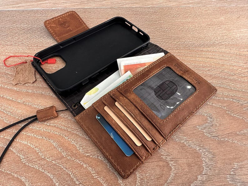 a brown wallet with a black case inside, placed on a wooden surface.