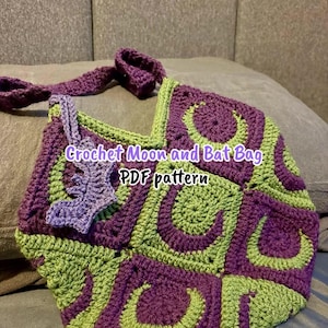 May include: A crochet bag constructed from square motifs featuring alternating purple and lime green crescent moon designs. A light purple bat-shaped applique is attached to the side. The text "Crochet Moon and Bat Bag PDF pattern" is overlaid.