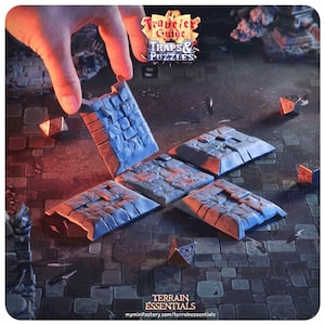 May include: A set of blue and gray stone tiles for tabletop gaming. The tiles are designed to represent a dungeon floor with a trap door. The tiles are part of a terrain essentials set for tabletop gaming.