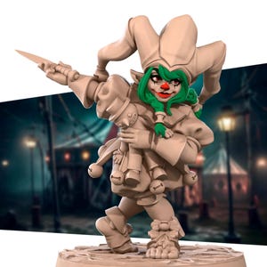 May include: A green-skinned, female jester figurine with a red clown nose and a painted smile. She is wearing a jester's hat and a costume with bells. She is holding a doll and a dagger.