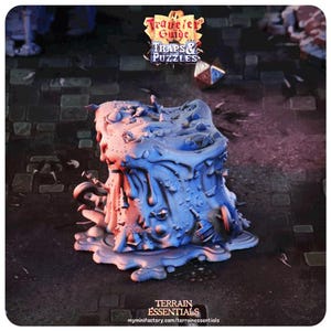 May include: A blue and gray resin miniature of a melting, gooey, and textured block with various details. The miniature is a terrain piece for tabletop games. The text "A Traveler's Guide Traps & Puzzles" is visible in the background.