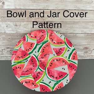 May include: A round bowl and jar cover pattern featuring a watermelon design. The cover has a light gray background with red watermelon slices, green rinds, and black seeds. Text on the image reads "Bowl and Jar Cover Pattern" and "*Step by step instructions with photos*".