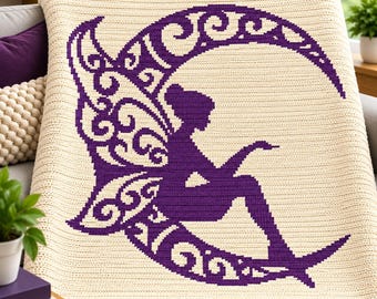 May include: A cream-coloured crochet blanket featuring a large, dark purple graphic design of a winged figure sitting on a crescent moon. The moon is decorated with intricate, swirling filigree patterns throughout its curved shape.