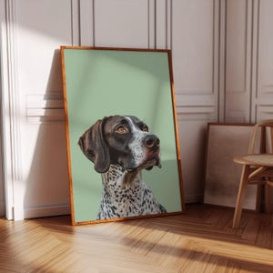 May include: A framed portrait of a black and white dog with brown eyes, looking up and to the right. The dog is against a light green background.