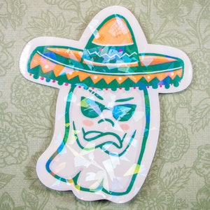 May include: A white ghost wearing a green and orange sombrero with sunglasses. The ghost has a grumpy expression.