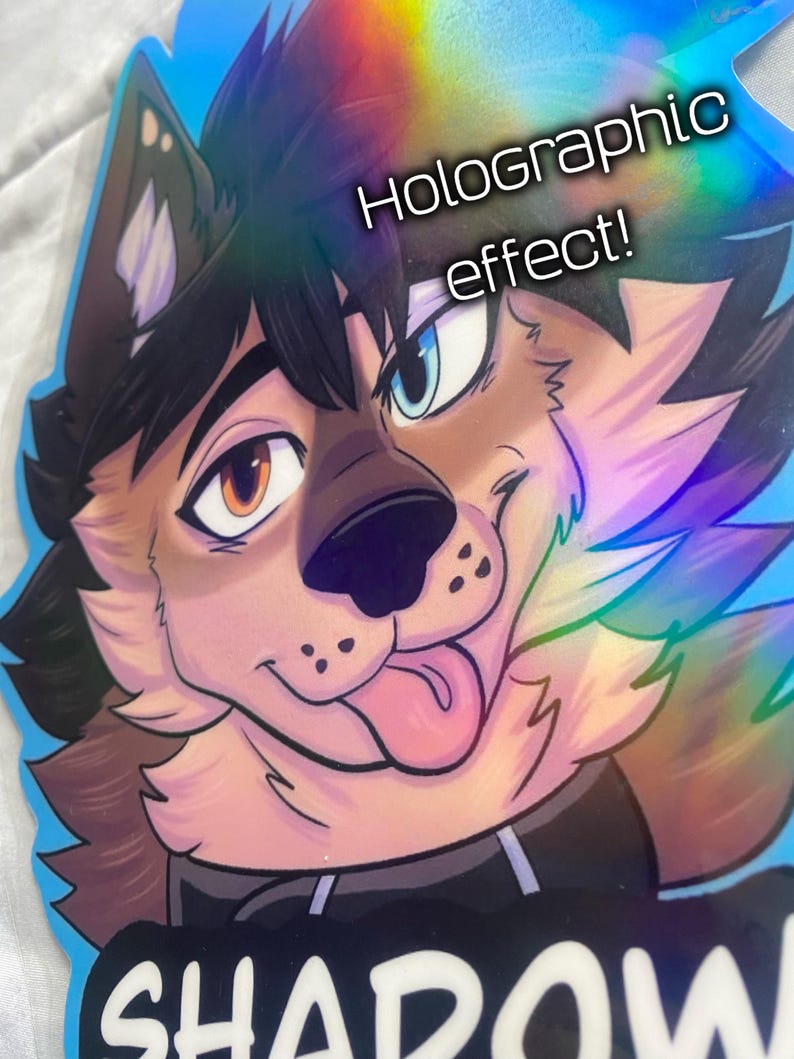 K&ouml;nnte beinhalten: Holografischer Aufkleber mit einem Cartoon-Wolf mit braunem und schwarzem Fell und blauem Hintergrund. Der Wolf hat ein braunes und ein blaues Auge, und seine Zunge h&auml;ngt heraus. Der Aufkleber hat den Text "Holographic effect!" und "SHADOW".