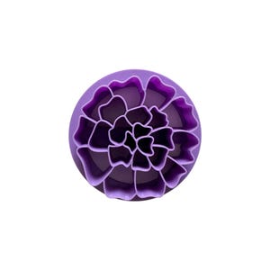 May include: A purple, circular cookie cutter in the shape of a flower. The cutter has a detailed design with multiple layers of petals, perfect for creating floral-shaped cookies or fondant decorations. The cutter is made of plastic.