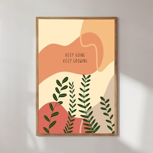Puede incluir: Una impresión de arte de pared imprimible con un diseño abstracto que presenta formas de color melocotón, beige y coral y hojas verdes. La impresión incluye el texto "Keep Going Keep Growing".