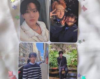 May include: Four rectangular photo cards featuring images of people. One card shows a person in a white jacket, another shows two people making peace signs, a third shows a person in a striped sweater, and the last shows a person in a suit. Decorative star and butterfly confetti.