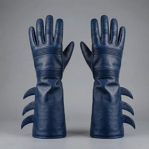 May include: A pair of navy blue leather gloves with a unique design. The gloves feature three curved, pointed extensions on the gauntlet cuffs. The gloves have horizontal ribbed detailing across the back of the hand and wrist.