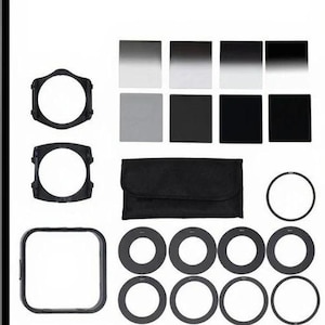 May include: A collection of photography filters and accessories, including square and circular filters, filter holders, and adapter rings. The filters range in color from clear to dark, and are arranged with a black carrying case.