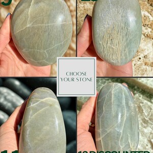 May include: Four polished, oval-shaped stones in varying shades of green and gray. The stones are held in hands, with the numbers 9, 10, 11, and 12 displayed next to each stone. The text "CHOOSE YOUR STONE" is in a white box. The text "12 DISCOUNTED WOBBLES" is also visible.
