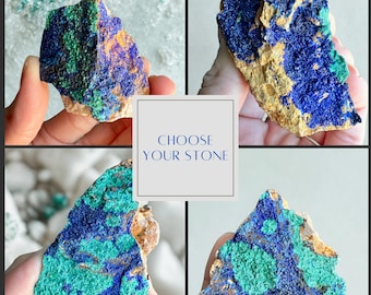 May include: Four samples of azurite mineral specimens, each with a unique pattern of deep blue and green hues. The text "CHOOSE YOUR STONE" is displayed in a white box, inviting the viewer to select their preferred piece.