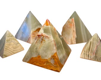 May include: Five decorative pyramid sculptures. The pyramids are made of a translucent stone with shades of green, orange, and white. The pyramids are arranged in a group, each with a unique pattern and color variation.