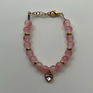 pink heart gemstone with golden assets