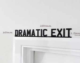 May include: Black metal sign with the text "DRAMATIC EXIT" in all caps. The sign is 28 inches wide and 1.5 inches thick.