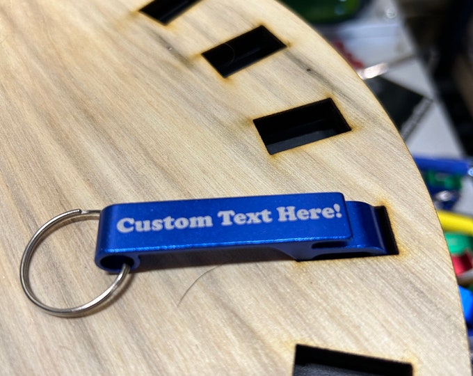 Personalized engraved aluminum bottle can opener keychains in assorted colors.