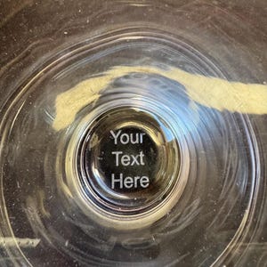 May include: A clear glass bowl with a circular etched area in the center that says "Your Text Here".