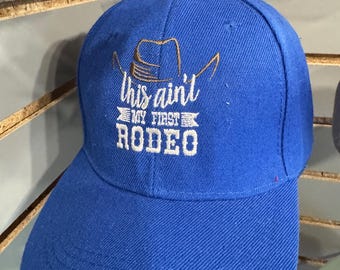 Embroidered This ain't my first rodeo hat. Blue cap with Velcro adjustable strap.