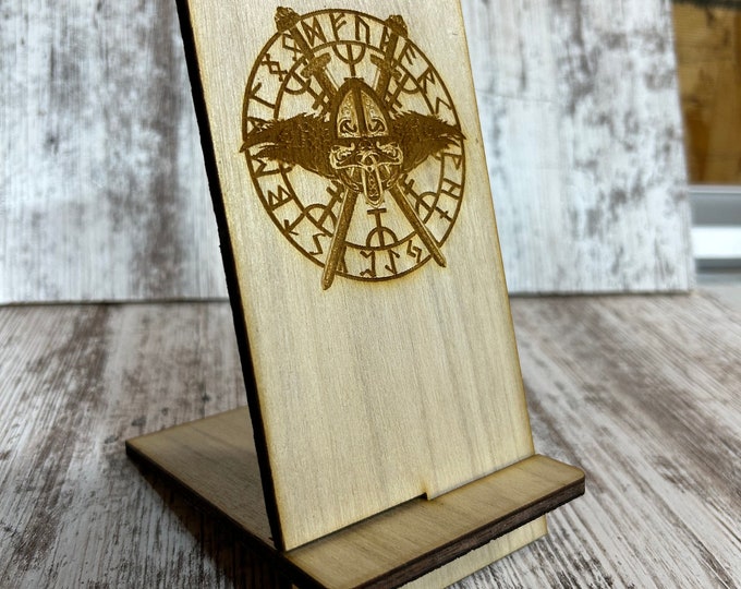 Unique cell phone stand with Viking runes theme.