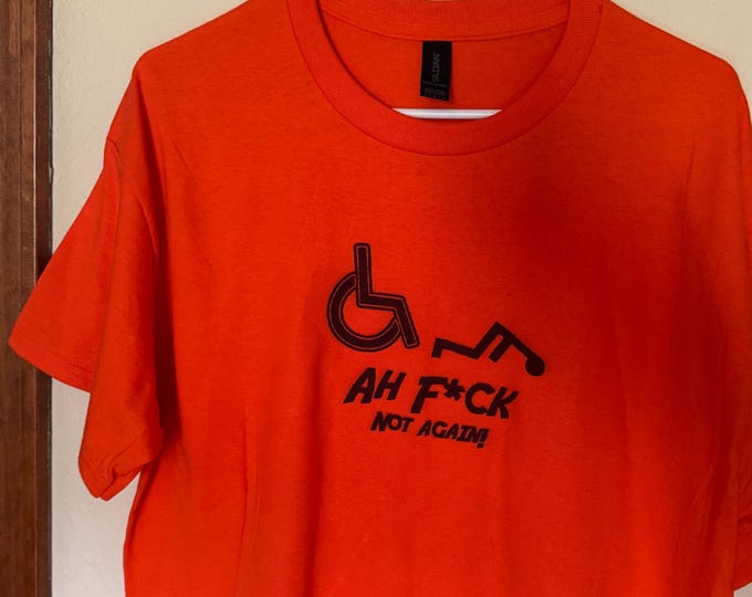 Funny T-shirt. Gildan cotton t-shirt with wheelchair humor printed on the front. Orange cotton shirt.