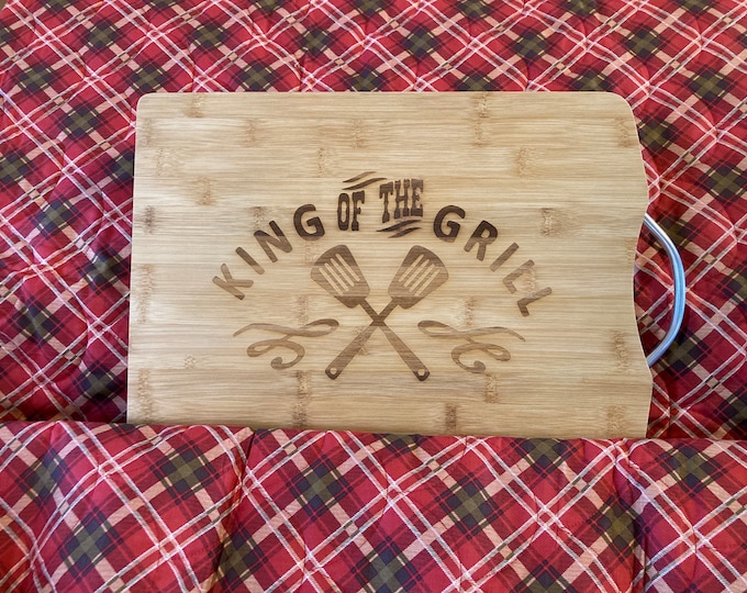 Bamboo engraved cutting board with king of the grill design.