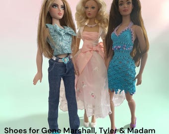 May include: Three fashion dolls standing side by side. The left doll wears a light blue patterned top and dark blue jeans. The center doll wears a pink dress with a white bolero. The right doll wears a blue crocheted dress. Text reads: Shoes for Gene Marshall, Tyler & Madam Alexander.
