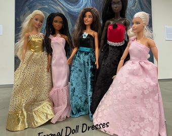 May include: Five fashion dolls standing in a row, wearing formal gowns in gold, light pink, teal, black and red, and a light pink floral textured fabric. The text "Formal Doll Dresses" is printed in black at the bottom of the image.