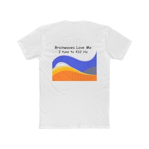 May include: White t-shirt with the text "Brainwaves Love Me I tune to 432 Hz". The graphic design features blue, orange, and yellow wavy shapes. The shirt is a crew neck style.