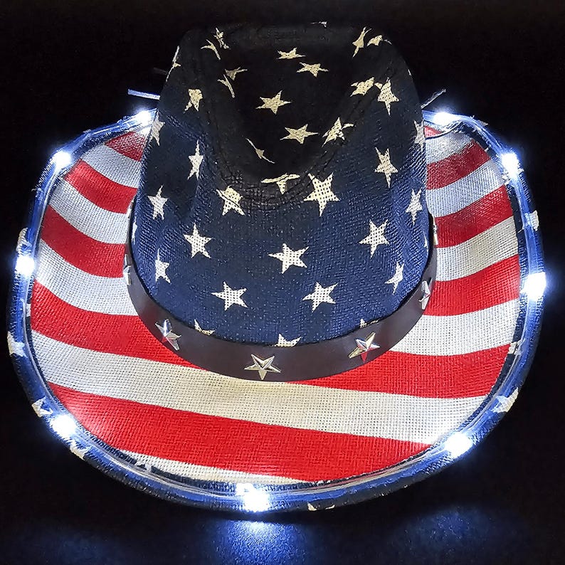 May include: A patriotic cowboy hat with a red and white striped brim and a navy blue crown adorned with white stars. The hat features a brown band and is illuminated with small white lights around the brim.