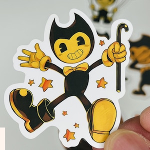 May include: A black and yellow cartoon character with a bow tie and a cane, standing on a white background with yellow stars. The character is from the video game Bendy and the Ink Machine.