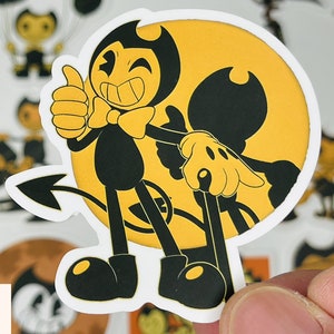 May include: A black and white cartoon sticker of Bendy and the Ink Machine characters. Bendy is a devil with a bow tie and a tail. He is giving a thumbs up. The other character is a black and white ink demon with a yellow background.