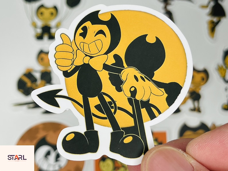 May include: A black and white cartoon sticker of Bendy and the Ink Machine characters. Bendy is a devil with a bow tie and a tail. He is giving a thumbs up. The other character is a black and white ink demon with a yellow background.
