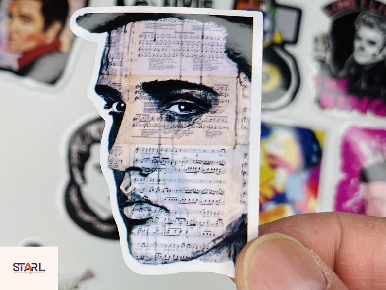 May include: Close-up of a sticker featuring a black and white portrait of a man with a sheet of music behind him. The man's eye is visible and the sheet music is faded and has a vintage look.