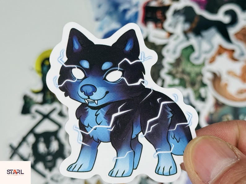 May include: A sticker featuring a cartoon dog with a black and blue color scheme, highlighted by white lightning bolt accents. The dog has glowing white eyes and a friendly expression. The sticker is held by a hand, with other stickers in the background.